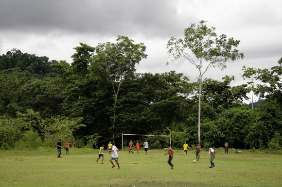 Boys plays soccer at a field surrounded by the jungle in San Josesito. - “Los paras y las Bacrim son el mismo perro con distinto collar”